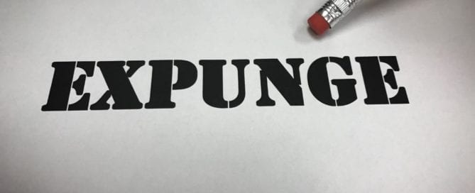 Pencil eraser near the word 'EXPUNGE' on paper.